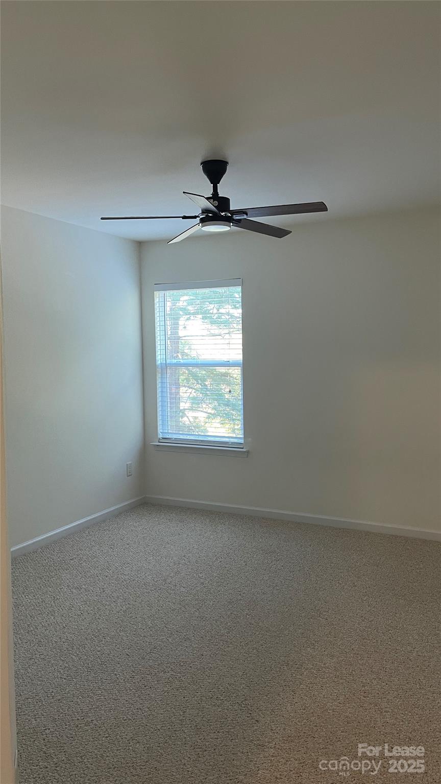1010 Ashbin Court Fort Mill, SC 29707 - Photo 16 of 23 an empty room with a window and a ceiling fan