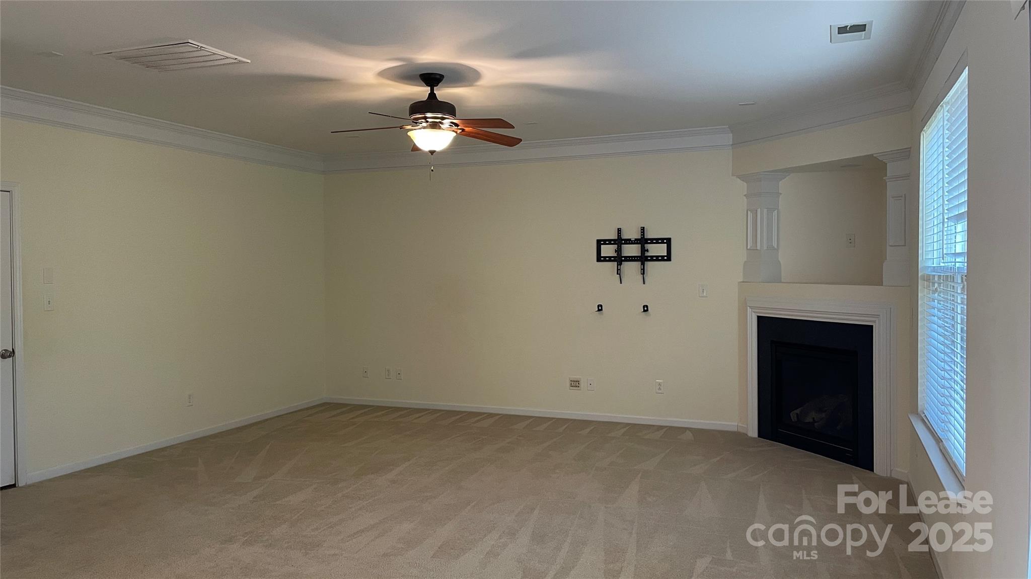1010 Ashbin Court Fort Mill, SC 29707 - Photo 9 of 23 a view of a room with a fireplace and ceiling fan