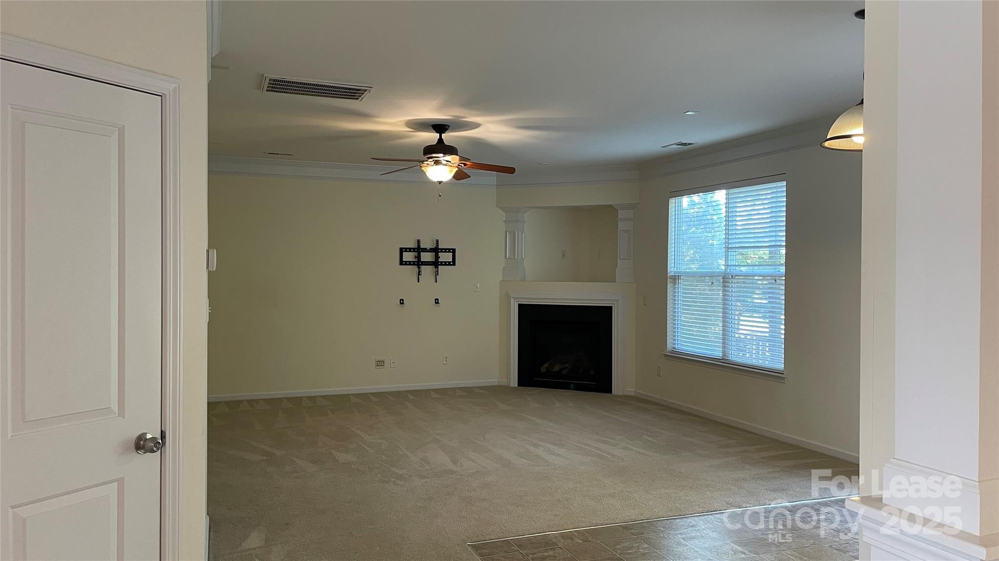 1010 Ashbin Court Fort Mill, SC 29707 - Photo 10 of 23 an empty room with windows and fireplace