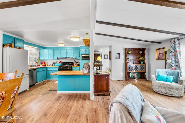a living room with furniture and a kitchen view