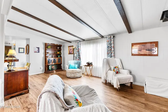 a bedroom with furniture and a wooden floor