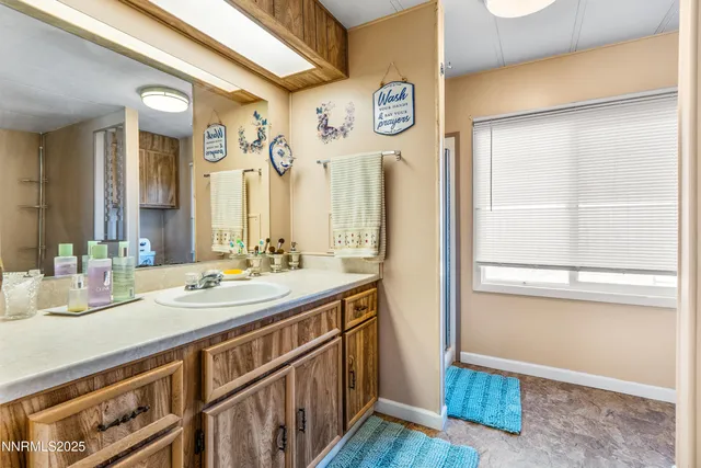 a bathroom with a double vanity sink and a mirror