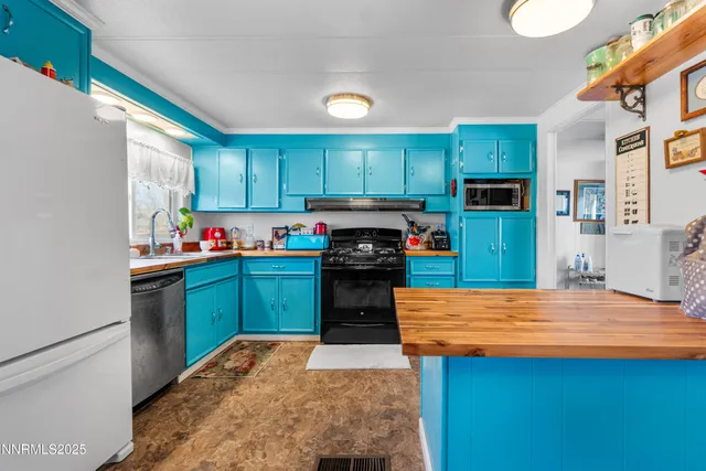 a kitchen with kitchen island a sink stainless steel appliances and cabinets
