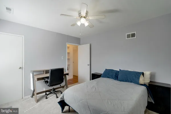 a bedroom with a bed and a desk