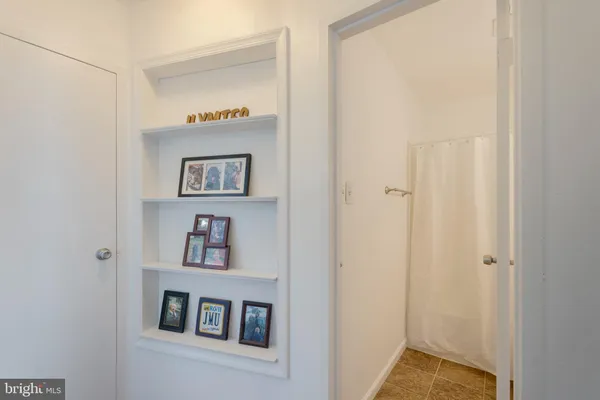 a view of a hallway with paintings on the wall