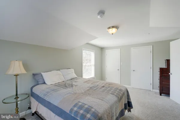 a bedroom with a bed and a night stand