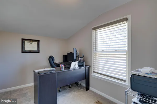 a work room with furniture and a window