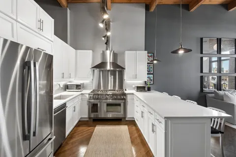 a kitchen with stainless steel appliances and white cabinets