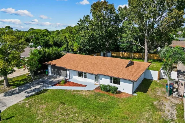 an aerial view of a house with swimming pool garden and patio