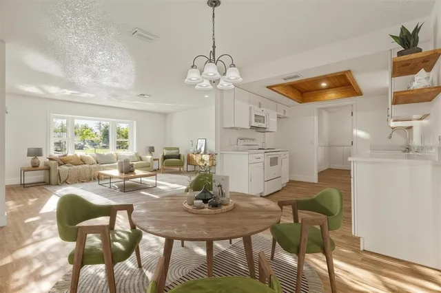 a kitchen with stainless steel appliances a stove a microwave and white cabinets
