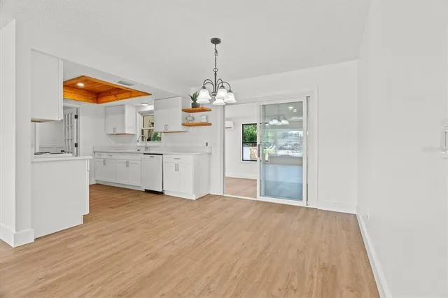 a kitchen with white cabinets and a sink