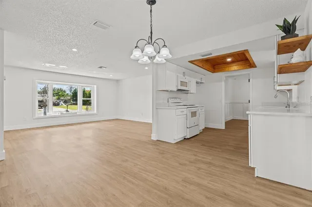 a kitchen with stainless steel appliances granite countertop a sink and cabinets