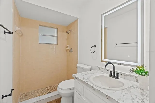 a utility room with cabinets washer and dryer