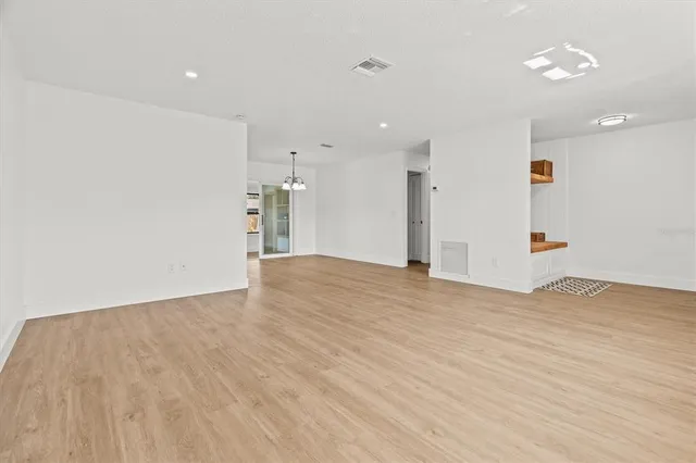 a view of a dining room with furniture and a chandelier