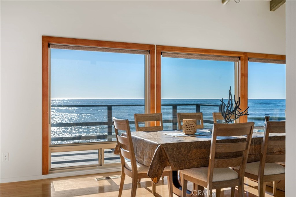 4865 Windsor Boulevard Cambria, CA 93428 - Photo 24 of 45 a dining room with furniture and a floor to ceiling window