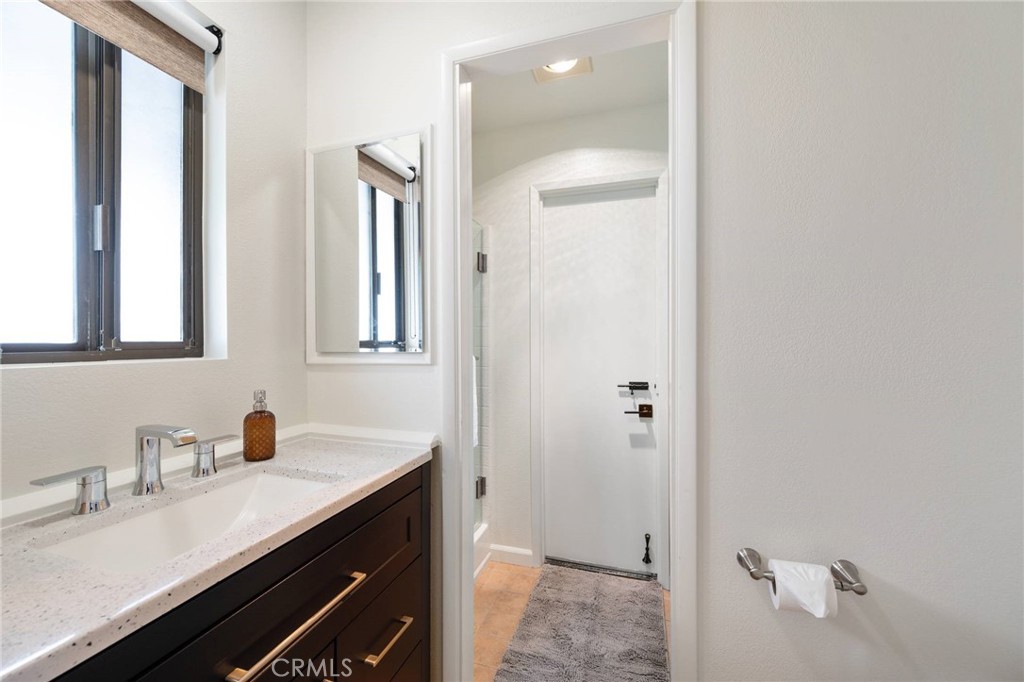 4865 Windsor Boulevard Cambria, CA 93428 - Photo 29 of 45 a bathroom with a granite countertop sink and a mirror