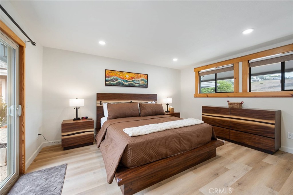 4865 Windsor Boulevard Cambria, CA 93428 - Photo 6 of 45 a bedroom with a bed and a painting on the wall