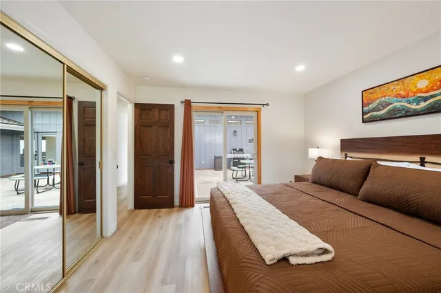 a bedroom with furniture and a large window