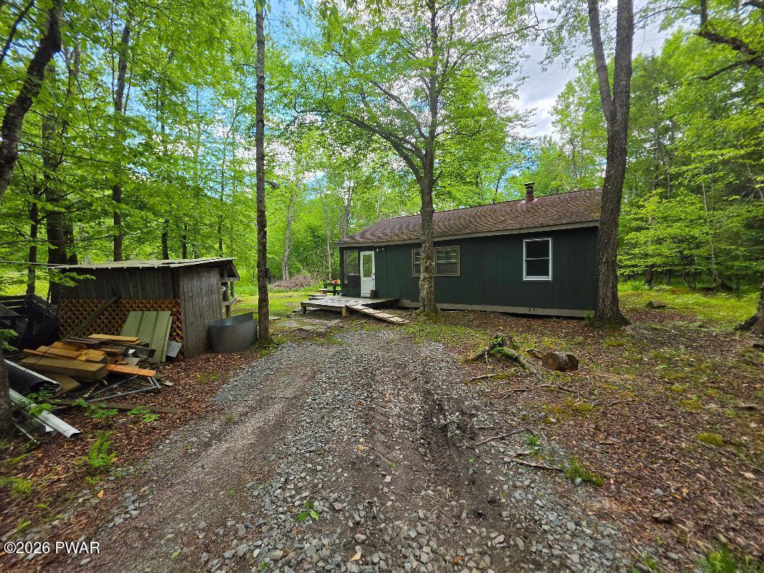 94 Swamp Road Pleasant Mount, PA 18453 - Photo 2 of 33 a backyard of a house with barbeque oven table and chairs