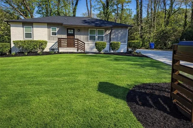 a front view of a house with garden and porch