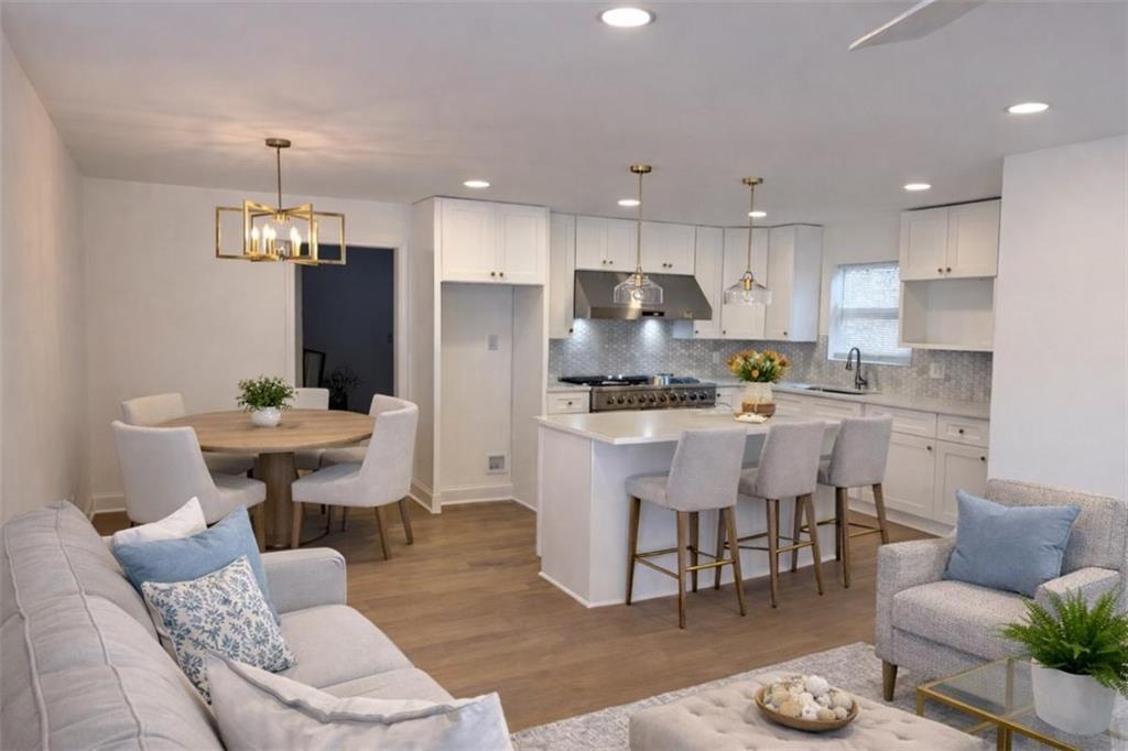 3687 Clovis Court Northwest Atlanta, GA 30331 - Photo 3 of 8 a kitchen with kitchen island stainless steel appliances a dining table chairs sink and cabinets