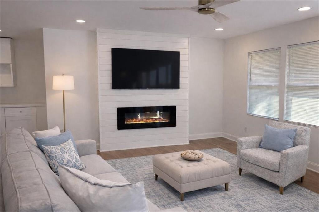 3687 Clovis Court Northwest Atlanta, GA 30331 - Photo 4 of 8 a living room with furniture a flat screen tv and a fireplace