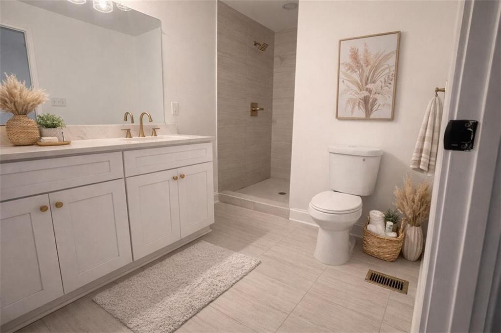 3687 Clovis Court Northwest Atlanta, GA 30331 - Photo 6 of 8 a bathroom with a toilet sink and mirror