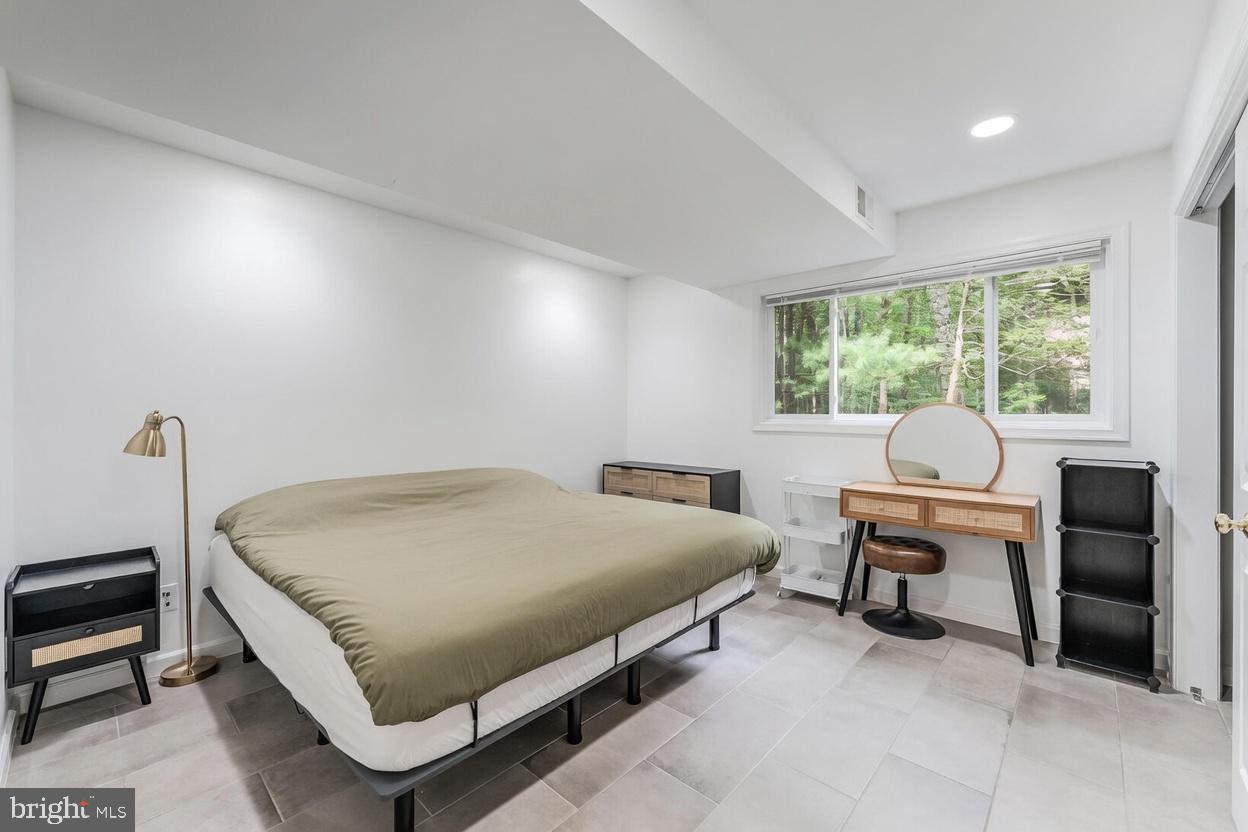 11621 Sourwood Lane Reston, VA 20191 - Photo 24 of 26 a bed room with a bed and a desk