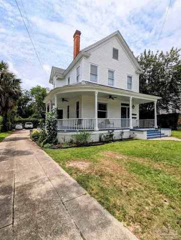 a front view of house with yard and swimming pool