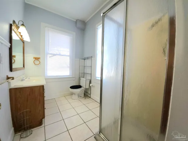 a bathroom with a sink a toilet and mirror