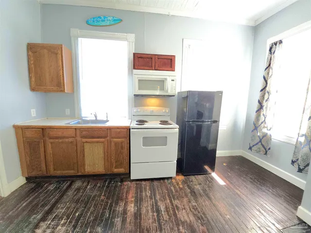 a kitchen with wooden cabinets and a sink
