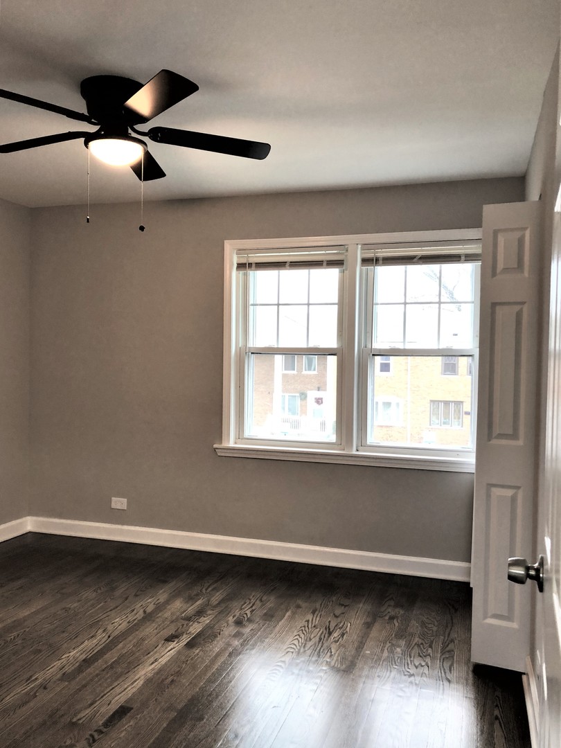 6360 Long Avenue Chicago, IL 60638 - Photo 17 of 29 a view of an empty room with wooden floor and a window