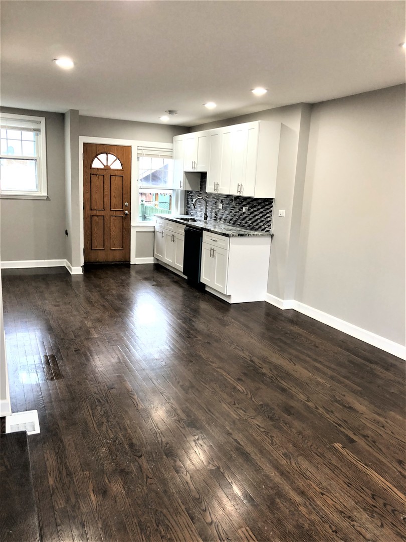 6360 Long Avenue Chicago, IL 60638 - Photo 7 of 29 a large kitchen with stainless steel appliances granite countertop a large counter top and a wooden floor