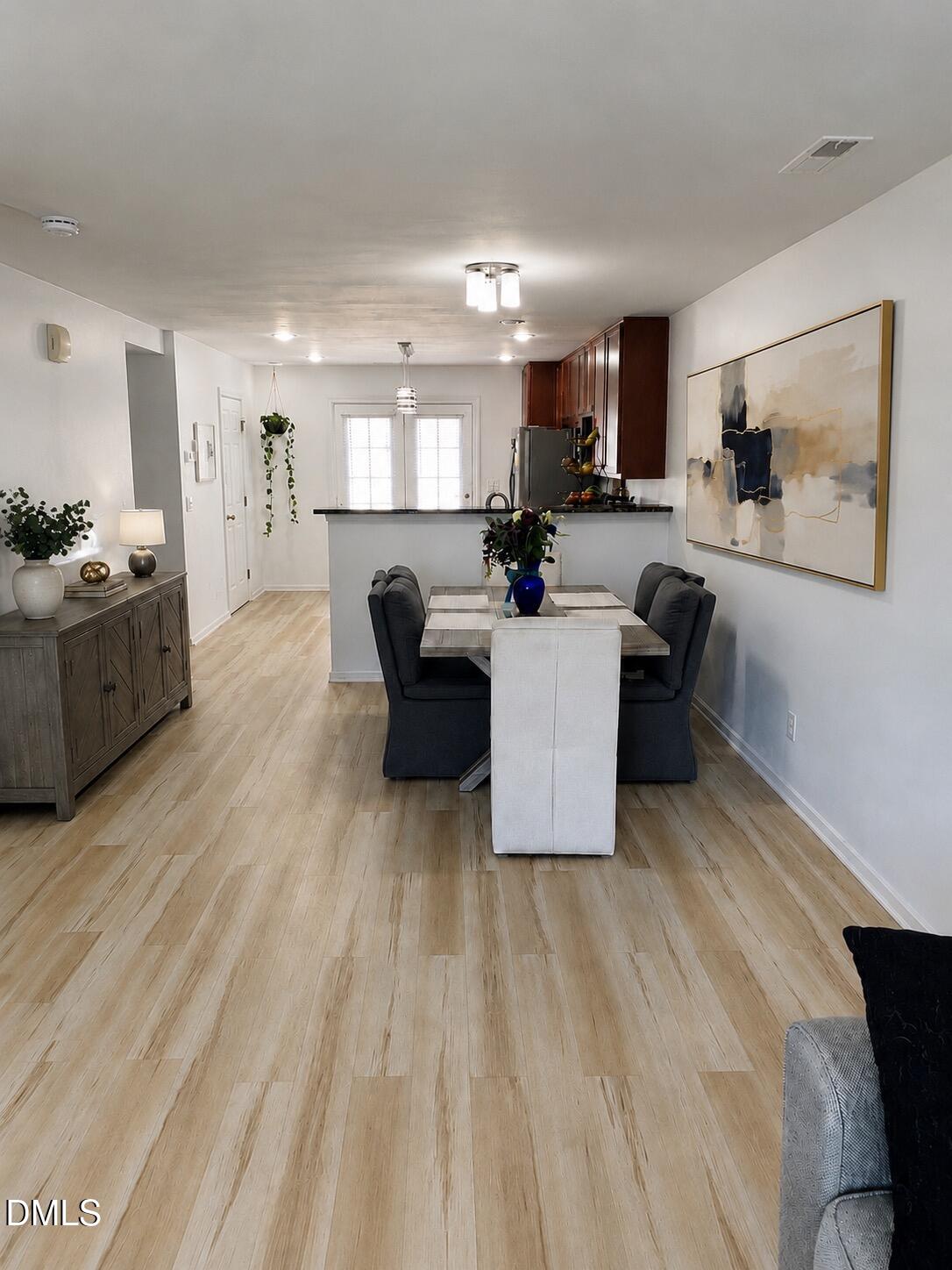 9826 Layla Avenue Raleigh, NC 27617 - Photo 7 of 19 a living room with couches and kitchen view with wooden floor