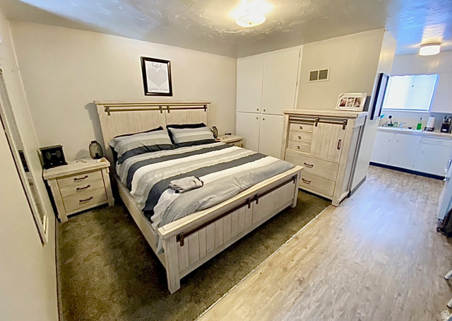 620 East 600 North Logan, UT 84321 - Photo 2 of 13 Bedroom with dark wood-type flooring, a closet, and a textured ceiling
