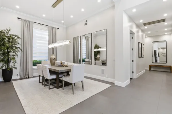 a bathroom with a sink a faucet a potted plant and a bathtub