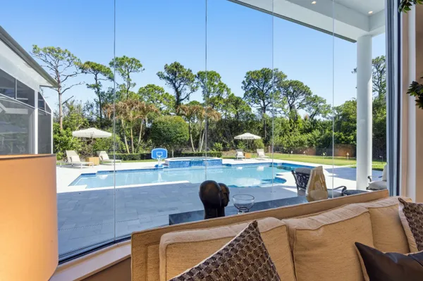 a view of a livingroom with furniture a chandelier and wooden floor