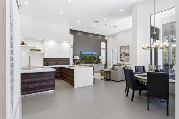 a spacious bedroom with a bed a couch and a flat screen tv