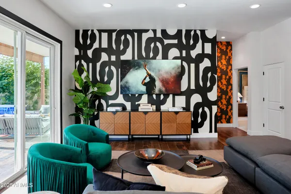 a living room with furniture and a floor to ceiling window