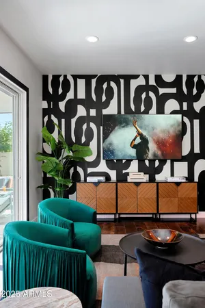 a living room with furniture and a potted plant