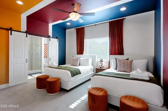 a bedroom with furniture and a ceiling fan