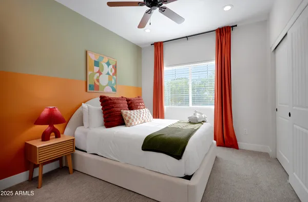 a bedroom with a bed and a chandelier