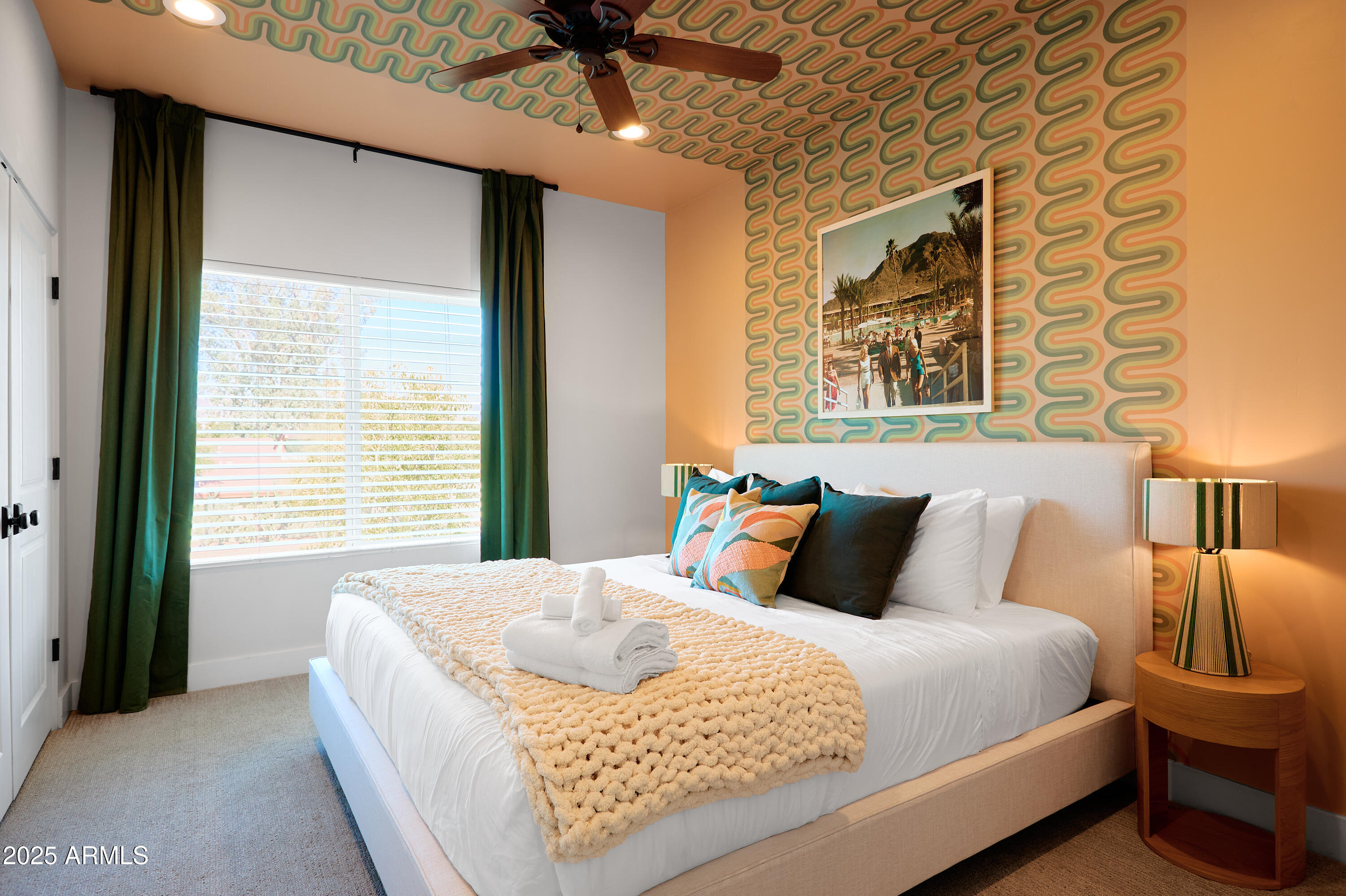 3229 East Campbell Avenue Phoenix, AZ 85018 - Photo 29 of 44 a bedroom with a large bed and a chandelier