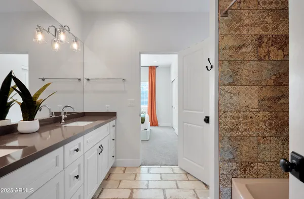 a bathroom with a granite countertop sink a mirror and shower