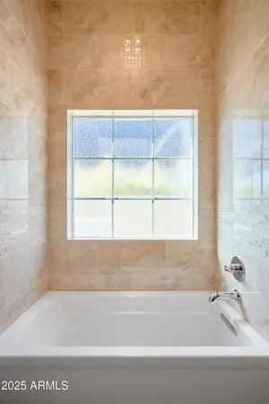 a bathroom with a bathtub and window