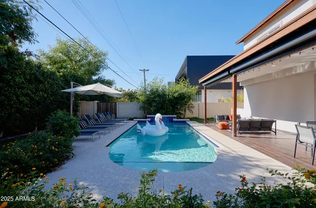 a view of a house with backyard and sitting area