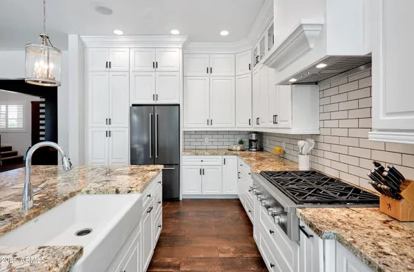 a kitchen with a sink stove and refrigerator
