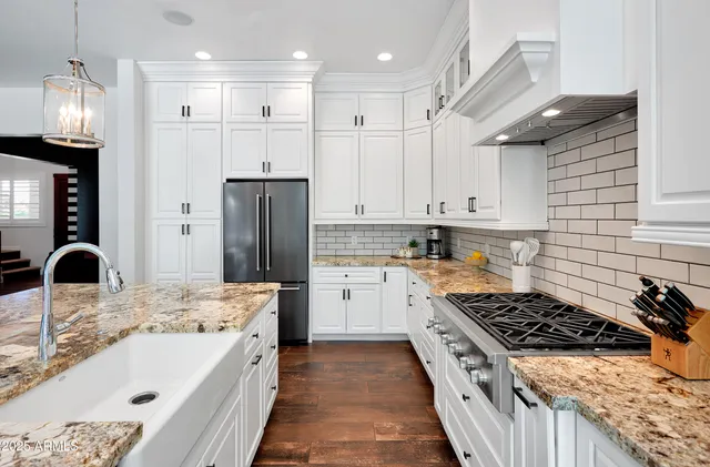 a kitchen with a sink stove and refrigerator
