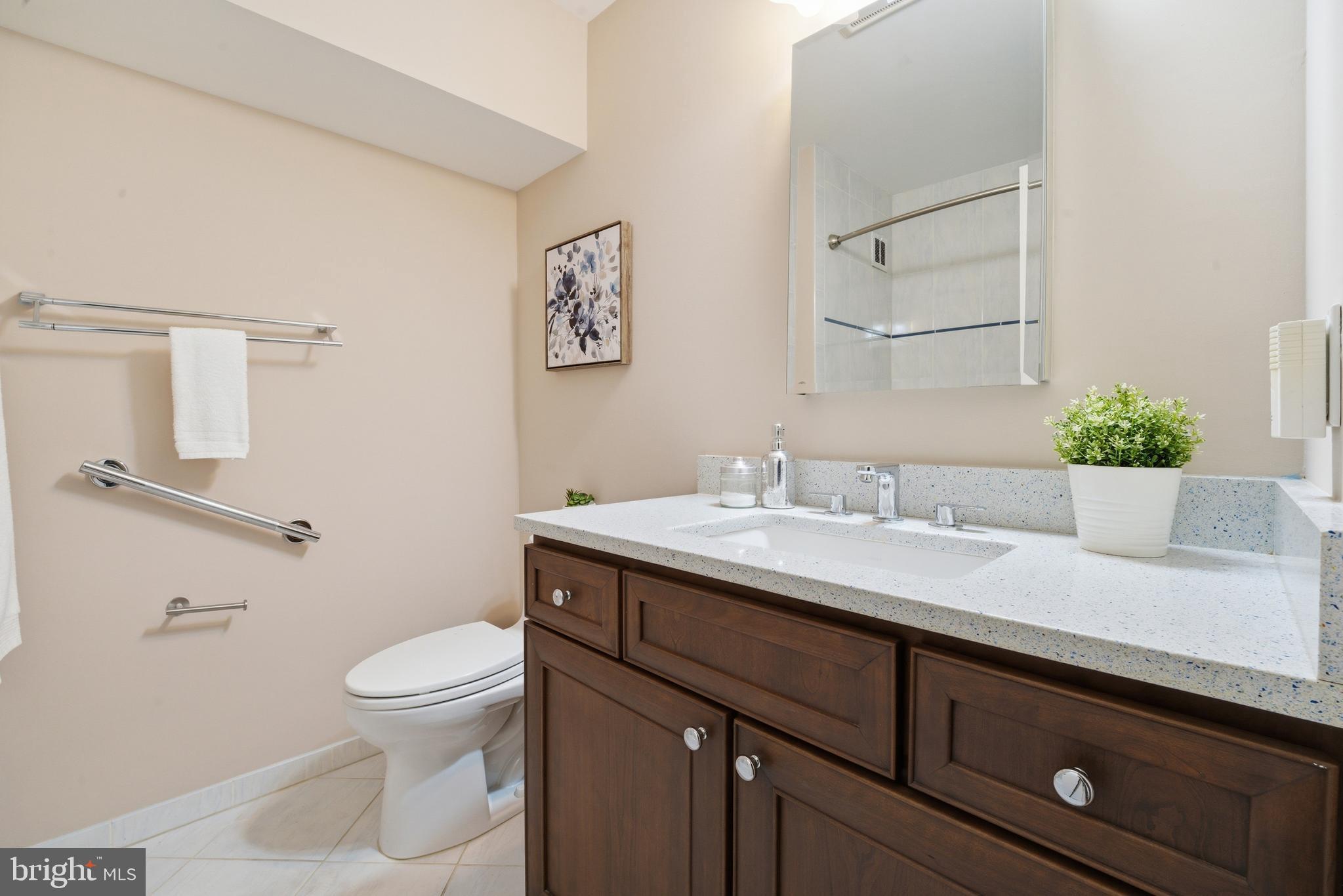13309 Old Forge Road Silver Spring, MD 20904 - Photo 43 of 52 a bathroom with a granite countertop sink a toilet and a mirror