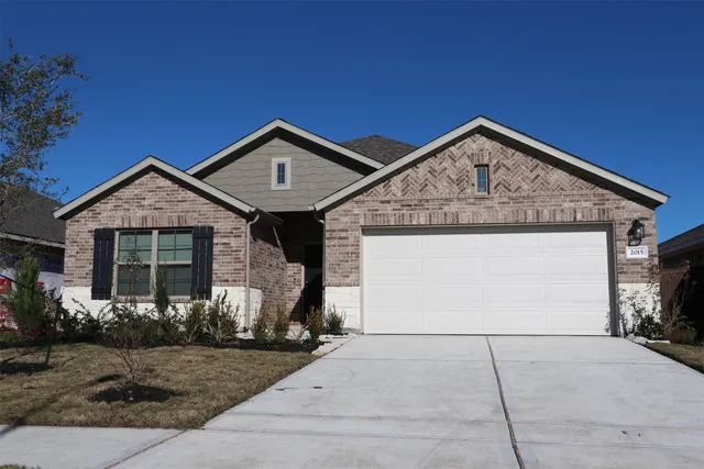 a front view of a house with garage